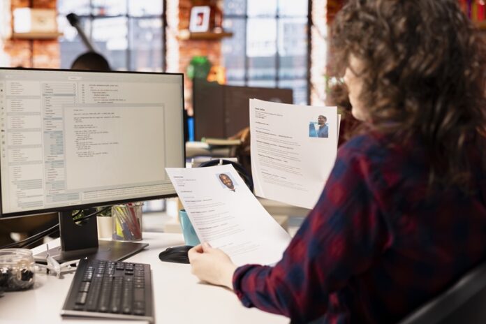 Startup HR worker identifying right candidates for job opening, reviewing resume